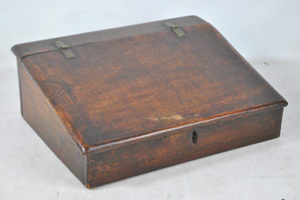 A stained beech baize lined writing slope with simple brass hinges