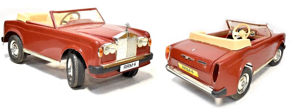 A 1980s Rolls Royce Corniche child s electric car in red lacking charger af length 120cm. Adam Partridge