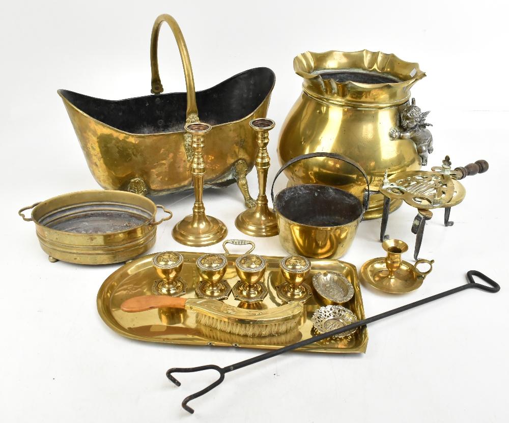 A large brass coal bucket with applied silvered cherub and crimped rim