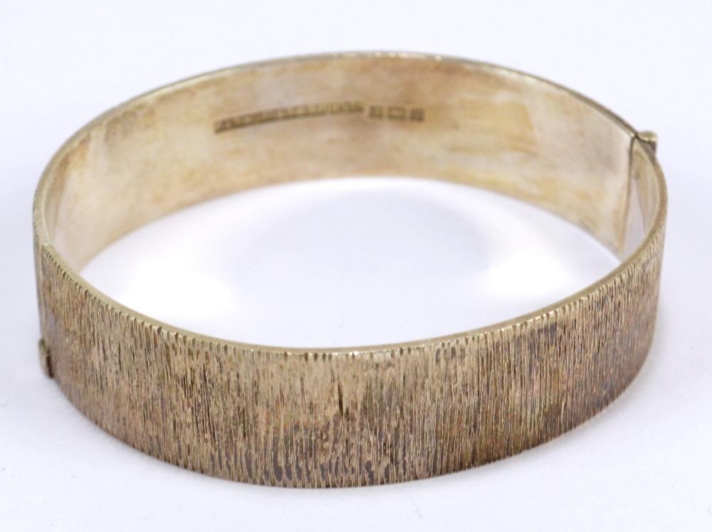 A hallmarked silver textured snap bangle, Birmingham 1974, patent number  1167637.