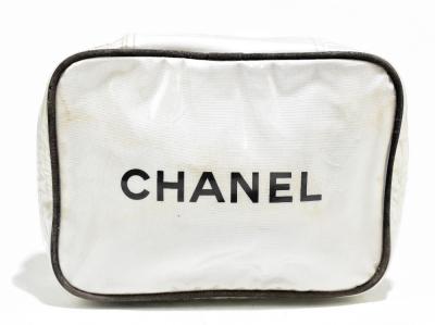 CHANEL; a cream textured leather make up bag with zip top, gold tone enamel  maker's logo to front, lined with monogrammed canvas, . | Adam  Partridge