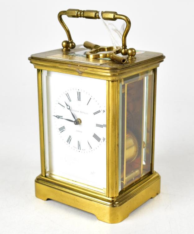 MATTHEW NORMAN; a brass cased carriage clock, the painted dial set with ...