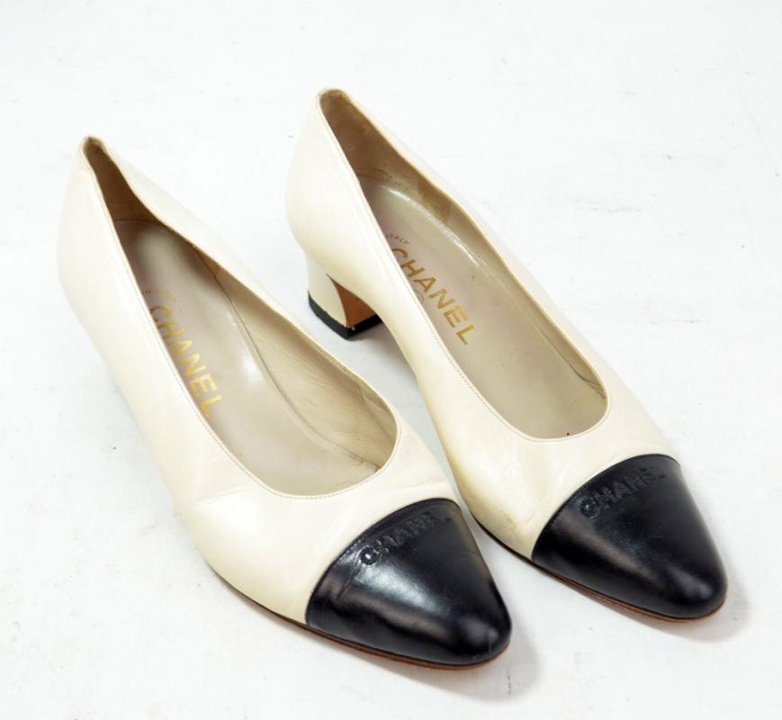 CHANEL; a pair of lady's white and black leather high heels, each with ...