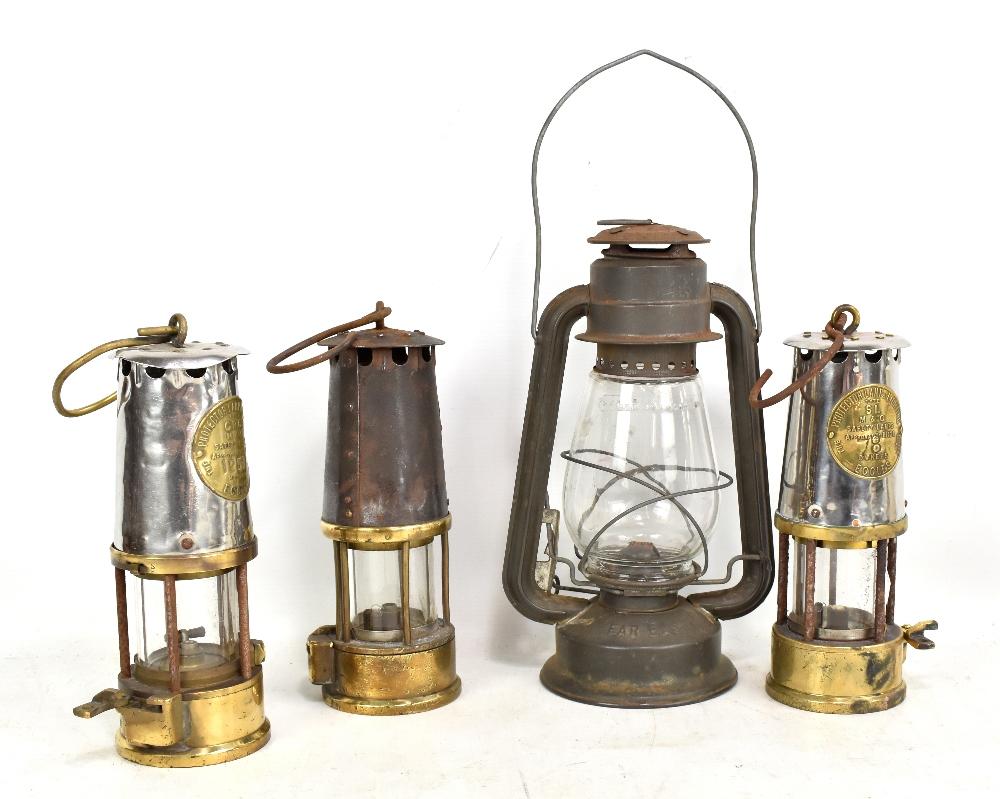 Three Protector Lamp & Lighting Co Ltd Eccles miners' safety lamps, two type SL and one type GR6S, height of each excluding loop 23cm (one badge indistinct), also a Chalwyn lamp (4). |