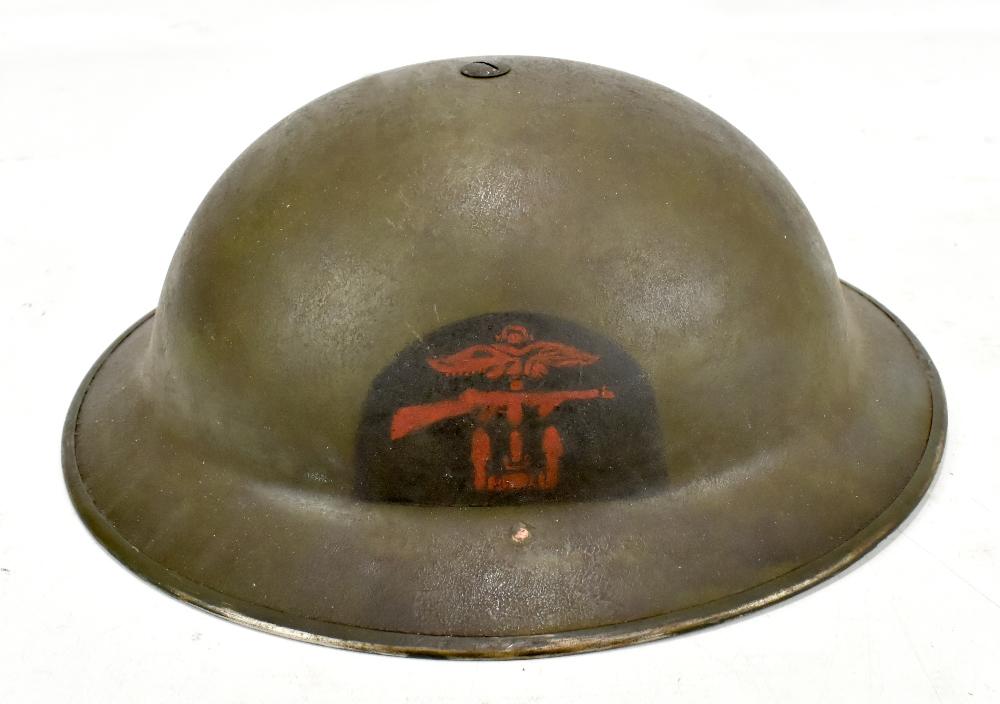 A WWII Combined Services Brodie type helmet with painted decal